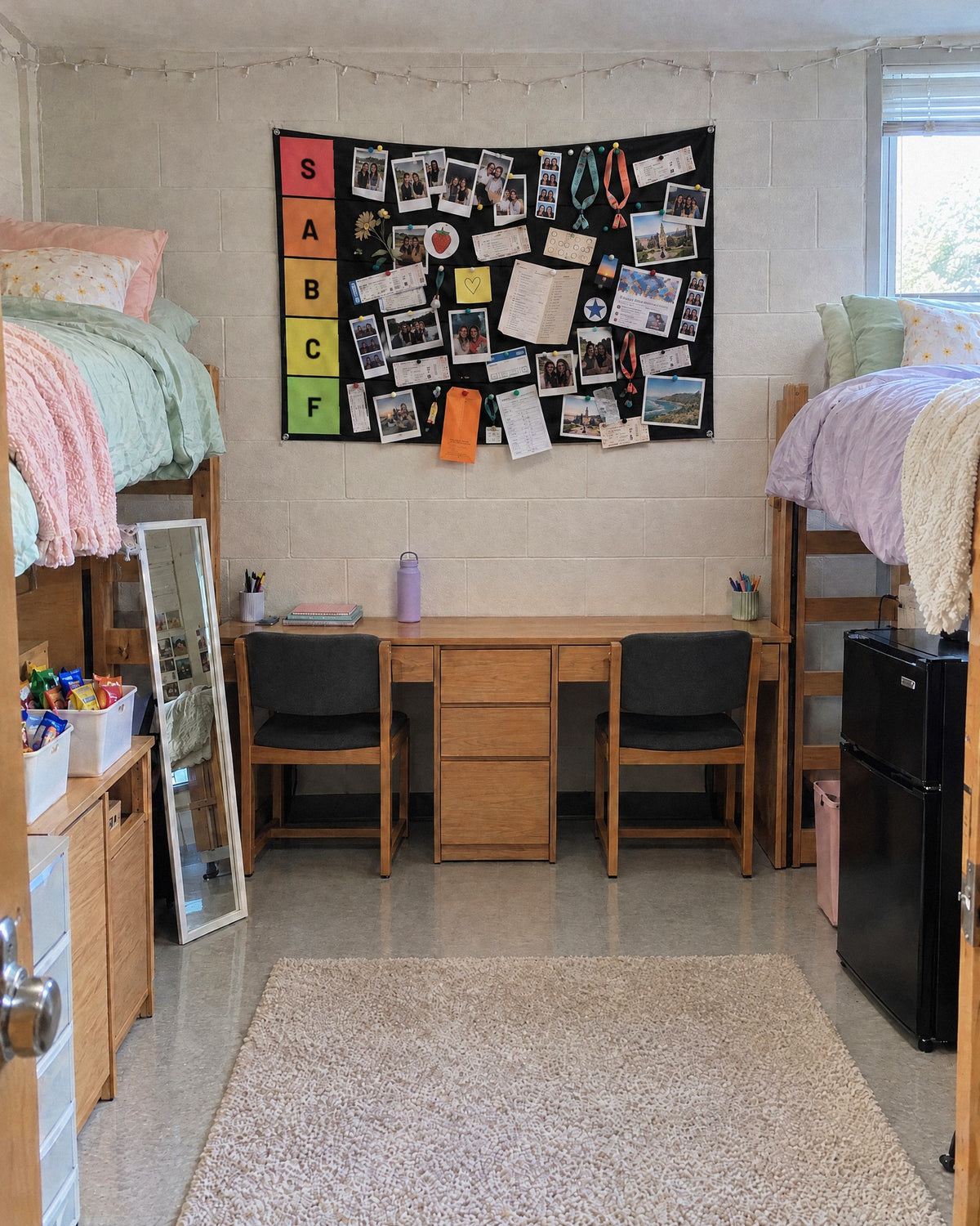 Packed tier list tapestry between two lofted beds in a shared dorm