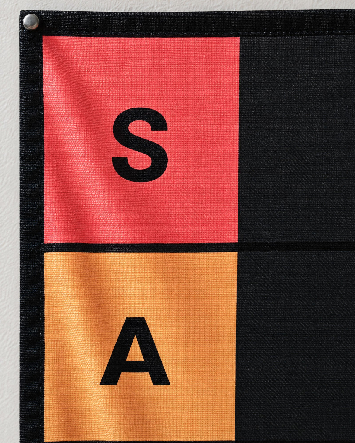 Close up of the S and A squares printed on the polyester tapestry