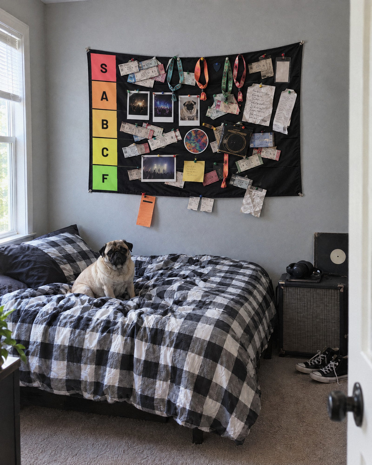 Tier list tapestry packed with concert tickets, wristbands and photos above a bed with a pug